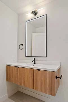 Renovated bathroom vanity with wood cabinets