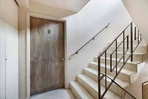 Stairwell and unit door before renovation